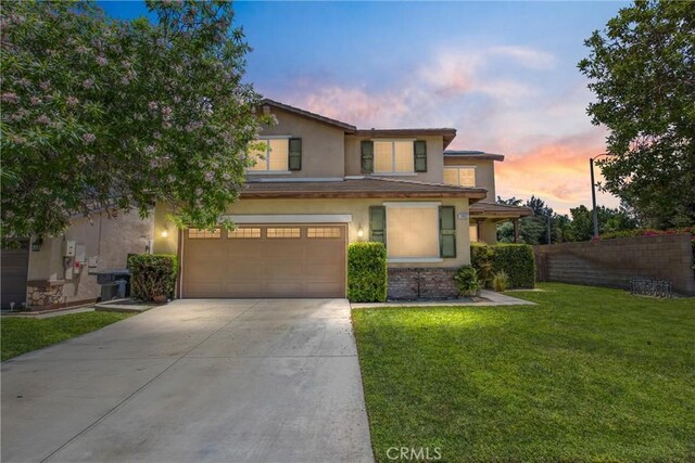 1802 Pummelo Dr, Redlands, CA 92374 - view of front facade with driveway, an attached garage, stucco siding, and stone siding