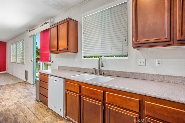 1802 Pummelo Dr, Redlands, CA 92374 - kitchen with dishwasher, light countertops, light wood finished floors, and brown cabinetry
