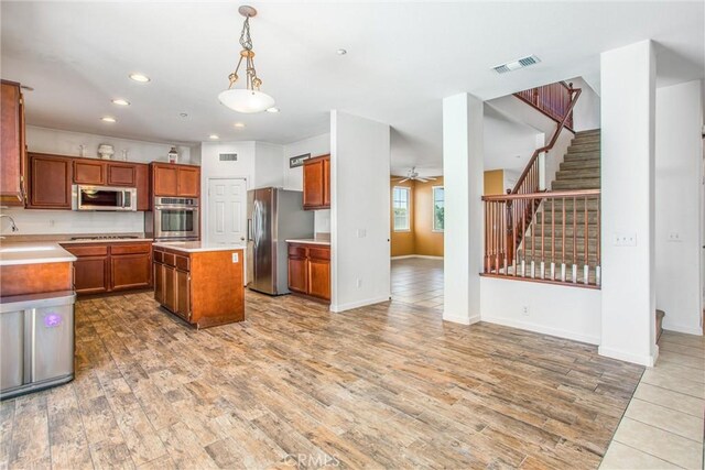 1802 Pummelo Dr, Redlands, CA 92374 - kitchen featuring appliances with stainless steel finishes, light wood-type flooring, a center island, light countertops, and recessed lighting