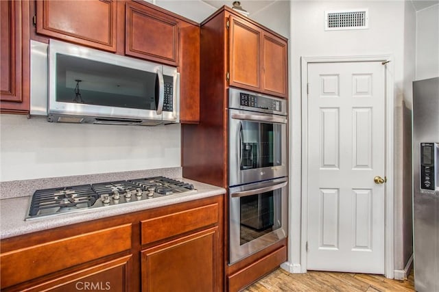 1802 Pummelo Dr, Redlands, CA 92374 - kitchen featuring stainless steel appliances, light countertops, and light wood-type flooring