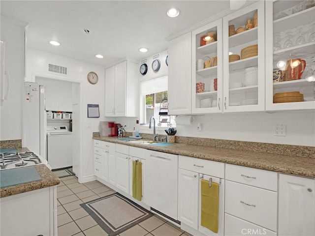 13815 Lexicon Ave, Sylmar, CA 91342 - kitchen with white appliances, washer / dryer, white cabinetry, glass insert cabinets, and light tile patterned floors