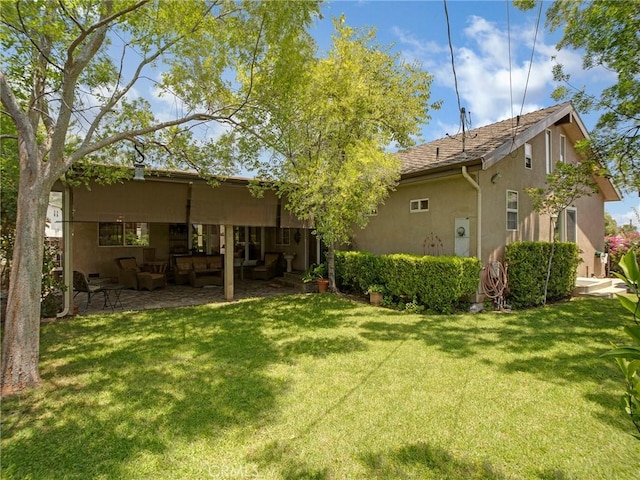 13815 Lexicon Ave, Sylmar, CA 91342 - back of property featuring stucco siding, a yard, an outdoor living space, and a patio