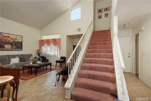 2508 Starbrite Ave, Rosamond, CA 93560 - staircase with wood finished floors and high vaulted ceiling