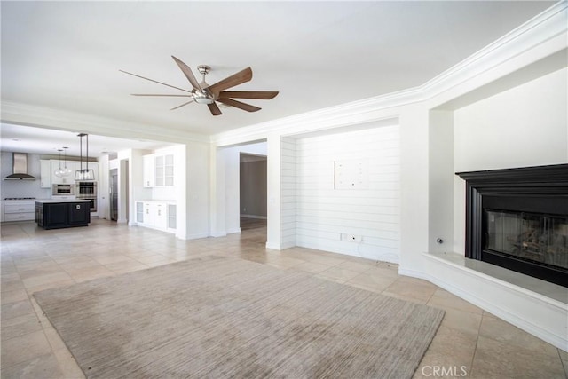 45118 Riverstone Ct, Temecula, CA 92592 - unfurnished living room with light tile patterned flooring, ceiling fan, a glass covered fireplace, and crown molding