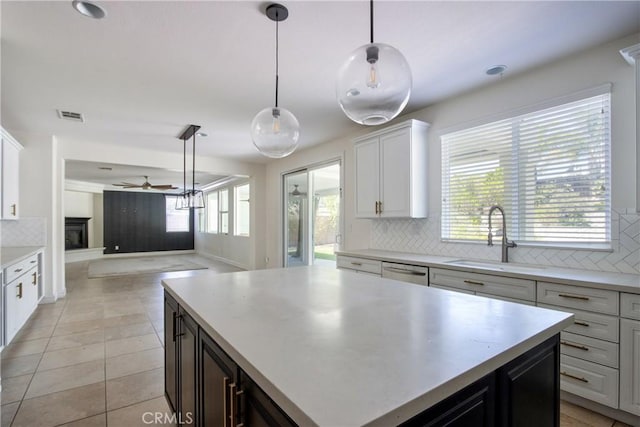45118 Riverstone Ct, Temecula, CA 92592 - kitchen featuring backsplash, light countertops, ceiling fan, decorative light fixtures, and open floor plan