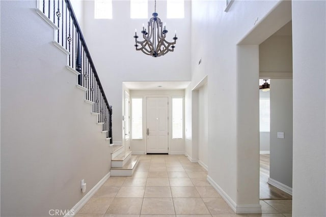 45118 Riverstone Ct, Temecula, CA 92592 - foyer entrance with stairway, a chandelier, light tile patterned floors, and a high ceiling