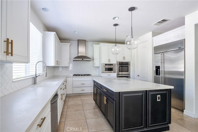 45118 Riverstone Ct, Temecula, CA 92592 - kitchen with wall chimney exhaust hood, appliances with stainless steel finishes, dark cabinetry, white cabinets, and light countertops