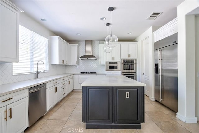 45118 Riverstone Ct, Temecula, CA 92592 - kitchen with stainless steel appliances, wall chimney range hood, white cabinetry, a center island, and recessed lighting