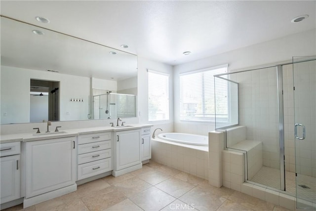 45118 Riverstone Ct, Temecula, CA 92592 - full bathroom with double vanity, a shower stall, a bath, tile patterned floors, and recessed lighting