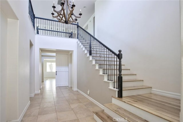 45118 Riverstone Ct, Temecula, CA 92592 - staircase with a chandelier and a towering ceiling