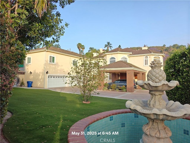 19910 Tennessee Trl, Walnut, CA 91789 - back of property with a garage, a yard, and stucco siding