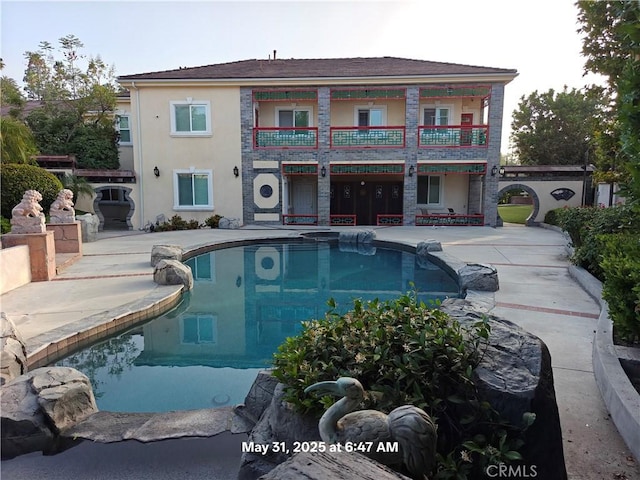 19910 Tennessee Trl, Walnut, CA 91789 - rear view of house featuring a patio area, an outdoor pool, a balcony, and stucco siding