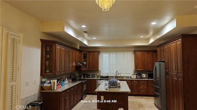 19910 Tennessee Trl, Walnut, CA 91789 - kitchen with stainless steel appliances, tasteful backsplash, glass insert cabinets, a kitchen island, and recessed lighting