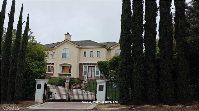 19910 Tennessee Trl, Walnut, CA 91789 - view of front of house featuring stucco siding, a chimney, and a gate