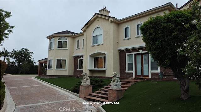 19910 Tennessee Trl, Walnut, CA 91789 - multi unit property featuring stucco siding, a chimney, a front yard, and brick siding