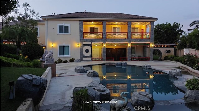 19910 Tennessee Trl, Walnut, CA 91789 - rear view of property featuring a balcony, a patio, stucco siding, and an outdoor pool