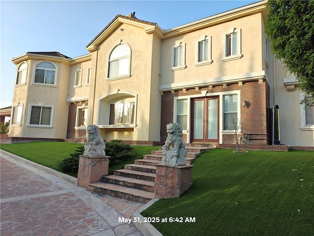 19910 Tennessee Trl, Walnut, CA 91789 - townhome / multi-family property with french doors, stucco siding, a front yard, and brick siding