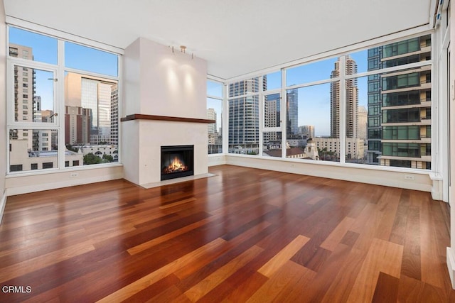 1205 Pacific Hwy Unit 1005, San Diego, CA 92101 - unfurnished living room featuring a city view, a fireplace with flush hearth, wood finished floors, and floor to ceiling windows