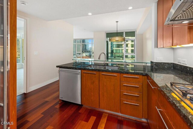 1205 Pacific Hwy Unit 1005, San Diego, CA 92101 - kitchen with appliances with stainless steel finishes, wall chimney exhaust hood, dark wood-style floors, dark stone countertops, and recessed lighting