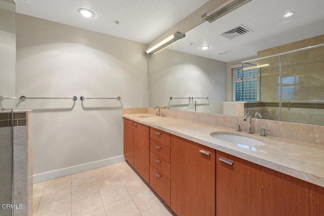 1205 Pacific Hwy Unit 1005, San Diego, CA 92101 - full bath with double vanity, tile patterned flooring, a stall shower, a textured ceiling, and recessed lighting