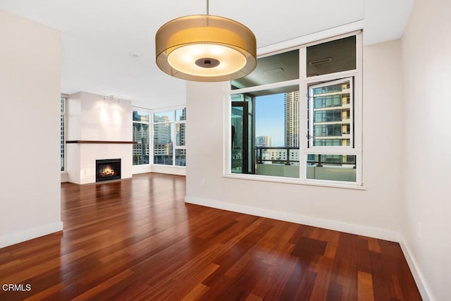 1205 Pacific Hwy Unit 1005, San Diego, CA 92101 - unfurnished living room featuring wood finished floors, a lit fireplace, and a view of city