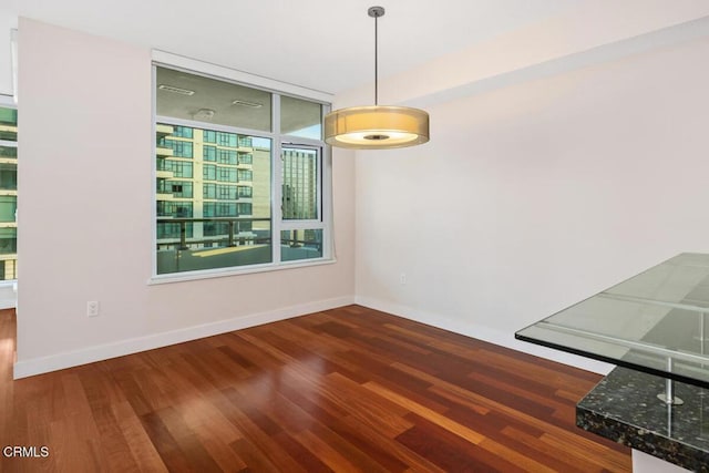 1205 Pacific Hwy Unit 1005, San Diego, CA 92101 - unfurnished dining area featuring wood finished floors and baseboards