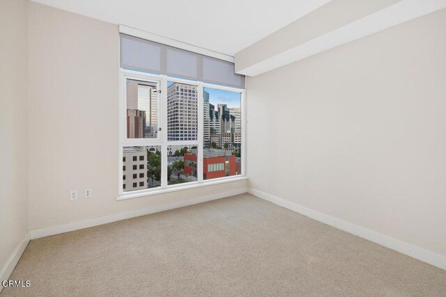 1205 Pacific Hwy Unit 1005, San Diego, CA 92101 - unfurnished room featuring carpet floors and baseboards