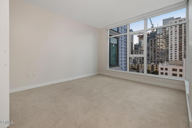 1205 Pacific Hwy Unit 1005, San Diego, CA 92101 - carpeted empty room featuring baseboards and a city view