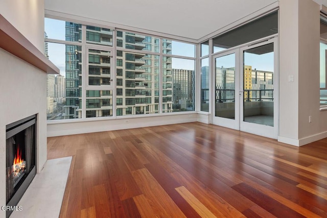 1205 Pacific Hwy Unit 1005, San Diego, CA 92101 - unfurnished living room featuring a high end fireplace, wood finished floors, and healthy amount of natural light
