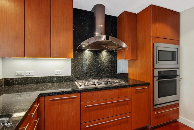 1205 Pacific Hwy Unit 1005, San Diego, CA 92101 - kitchen featuring stainless steel appliances, wall chimney exhaust hood, dark stone countertops, and backsplash