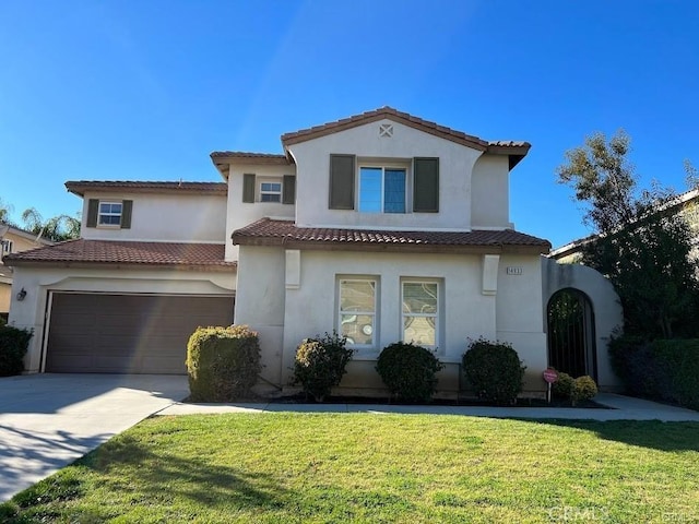 14933 Meridian Pl, Moreno Valley, CA 92555 - mediterranean / spanish-style home featuring concrete driveway, stucco siding, a tile roof, and a front yard