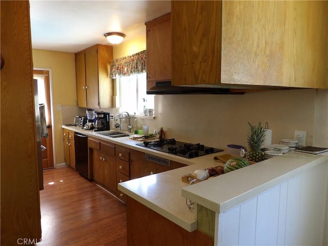 18735 Knapp St, Northridge, CA 91324 - kitchen with black appliances, brown cabinets, light countertops, and light wood finished floors