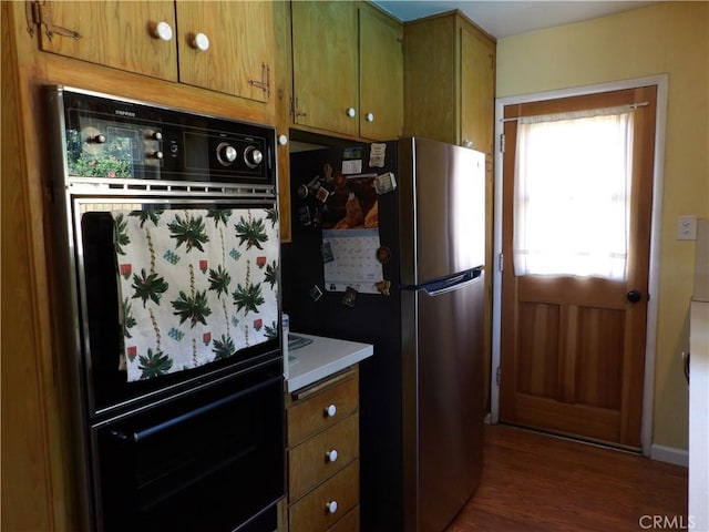 18735 Knapp St, Northridge, CA 91324 - kitchen with freestanding refrigerator, dark wood-style flooring, brown cabinetry, and light countertops