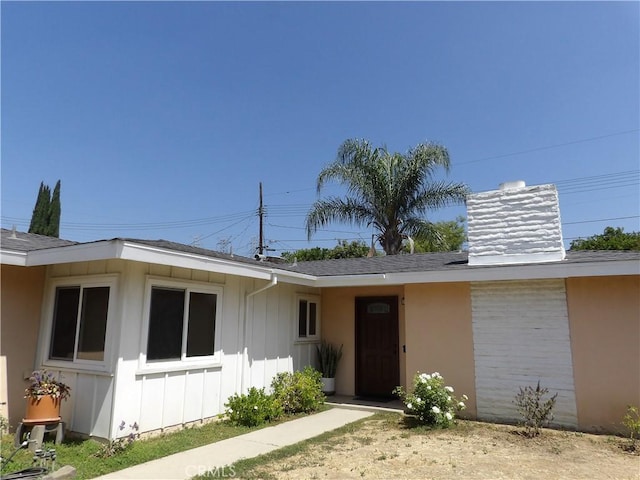 18735 Knapp St, Northridge, CA 91324 - view of front of house with board and batten siding, roof with shingles, and a chimney