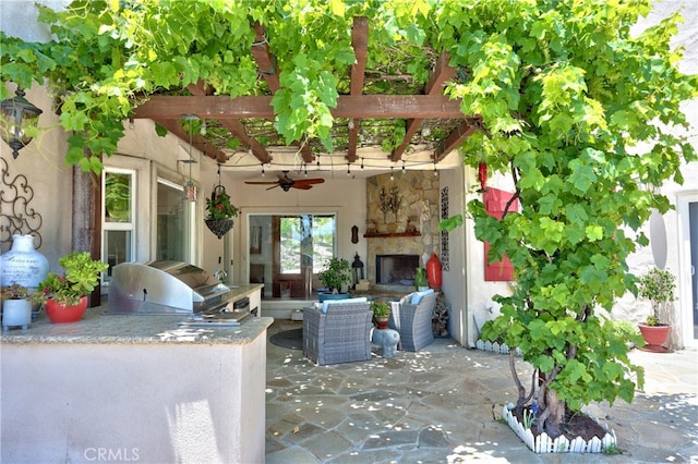 42768 El Calamar Rd, Temecula, CA 92590 - view of patio / terrace with an outdoor stone fireplace, an outdoor kitchen, and a ceiling fan