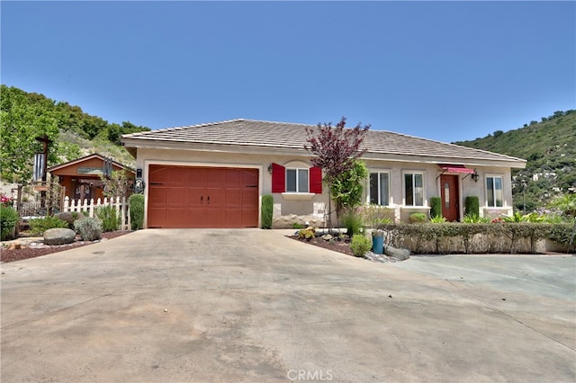 42768 El Calamar Rd, Temecula, CA 92590 - ranch-style home with concrete driveway, an attached garage, and stucco siding