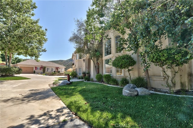42768 El Calamar Rd, Temecula, CA 92590 - view of front of house with stucco siding, a front lawn, concrete driveway, and a garage