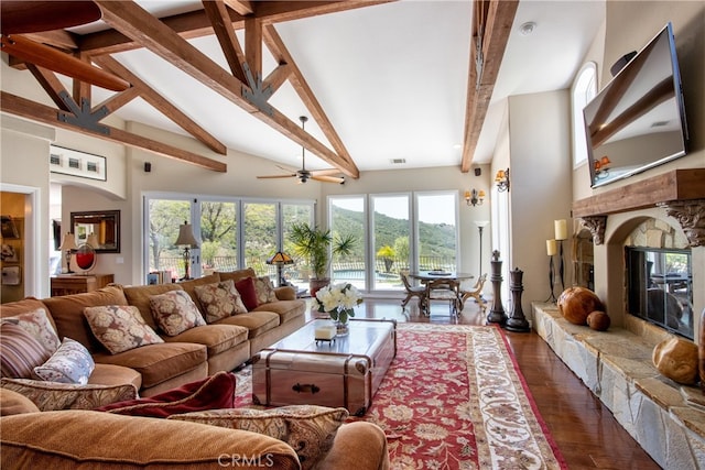 42768 El Calamar Rd, Temecula, CA 92590 - living area with beam ceiling, a glass covered fireplace, dark wood-type flooring, high vaulted ceiling, and a ceiling fan