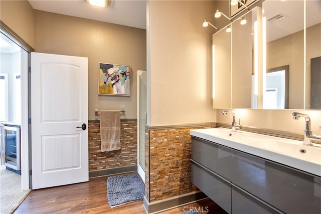42768 El Calamar Rd, Temecula, CA 92590 - full bathroom featuring double vanity, wood finished floors, an enclosed shower, and wine cooler