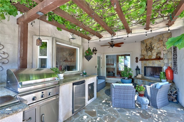 42768 El Calamar Rd, Temecula, CA 92590 - view of patio featuring an outdoor stone fireplace, an outdoor kitchen, ceiling fan, and a pergola