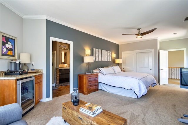 42768 El Calamar Rd, Temecula, CA 92590 - bedroom featuring wine cooler, light carpet, crown molding, a dry bar, and a closet