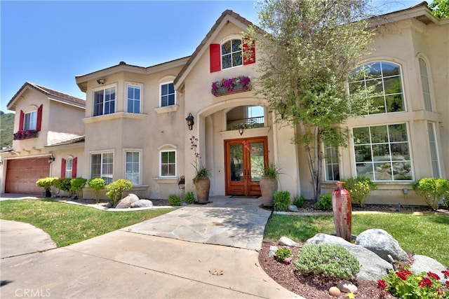 42768 El Calamar Rd, Temecula, CA 92590 - mediterranean / spanish home with french doors, stucco siding, a garage, a front yard, and driveway