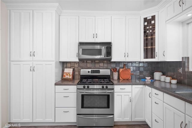 1715 Stanford Ave, Redondo Beach, CA 90278 - kitchen with appliances with stainless steel finishes, glass insert cabinets, white cabinetry, and tasteful backsplash