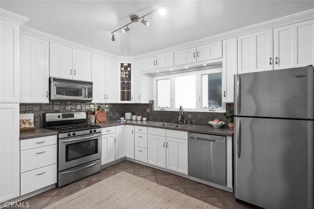 1715 Stanford Ave, Redondo Beach, CA 90278 - kitchen with appliances with stainless steel finishes, dark countertops, decorative backsplash, and white cabinetry