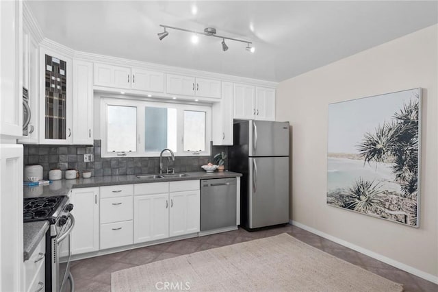 1715 Stanford Ave, Redondo Beach, CA 90278 - kitchen featuring stainless steel appliances, white cabinetry, dark countertops, tasteful backsplash, and glass insert cabinets