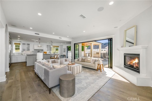 11385 Baskerville Rd, Rossmoor, CA 90720 - living area featuring a glass covered fireplace, recessed lighting, and light wood-type flooring