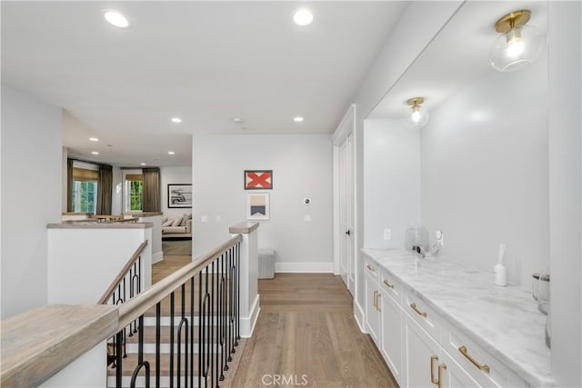 11385 Baskerville Rd, Rossmoor, CA 90720 - corridor with light wood-style flooring, recessed lighting, and an upstairs landing