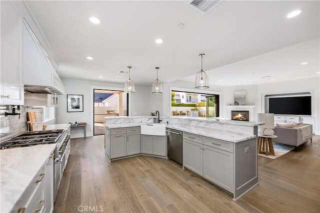 11385 Baskerville Rd, Rossmoor, CA 90720 - kitchen with gray cabinetry, stainless steel dishwasher, wood finished floors, open floor plan, and recessed lighting