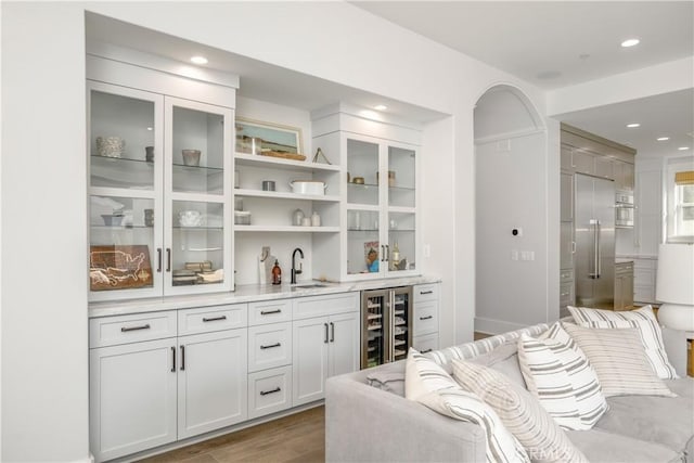 11385 Baskerville Rd, Rossmoor, CA 90720 - indoor wet bar with beverage cooler, dark wood finished floors, recessed lighting, and oven