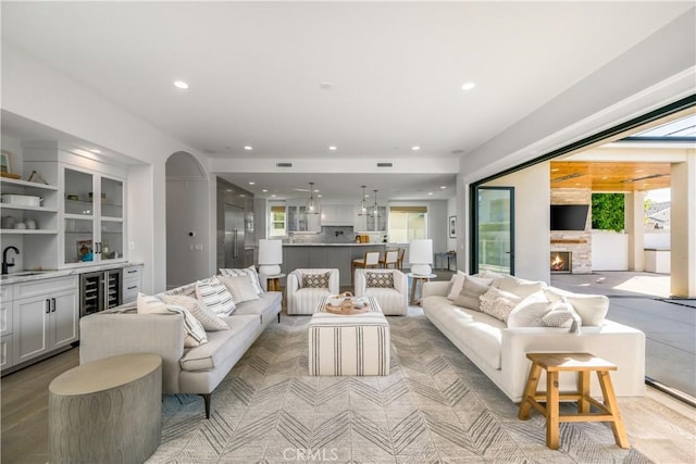 11385 Baskerville Rd, Rossmoor, CA 90720 - living area featuring bar area, a fireplace, recessed lighting, and beverage cooler
